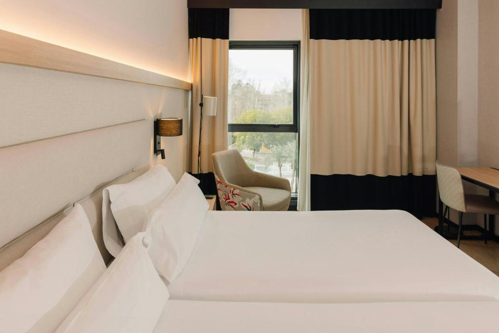 a hotel room with a bed and a window at Sercotel Amistad Murcia in Murcia