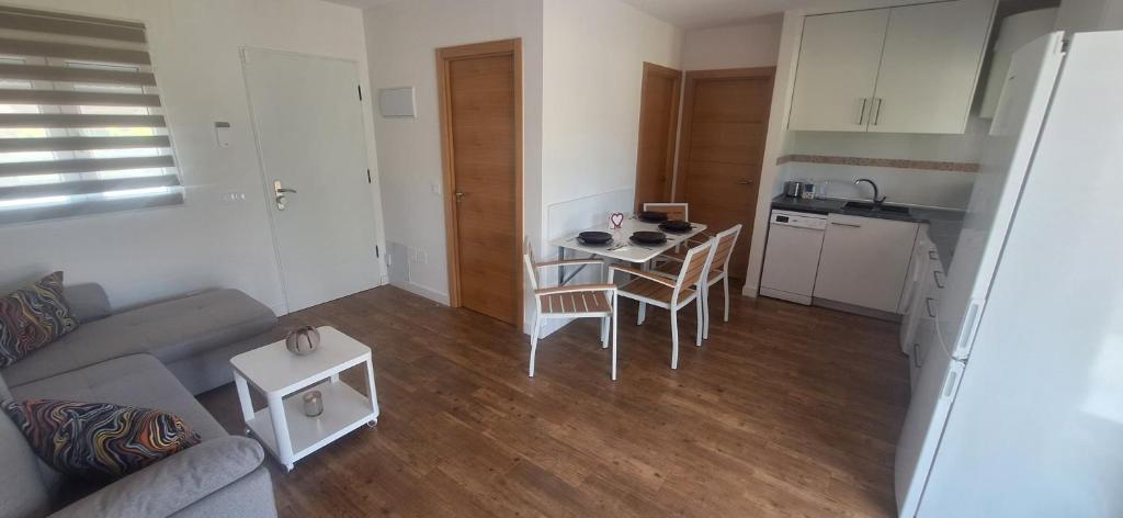 a living room with a couch and a table and a kitchen at Casa Lyly in Quincoces de Yuso