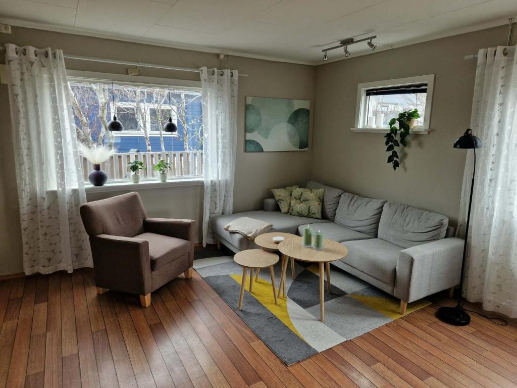 a living room with a couch and a table at Huset på øya in Vadsø