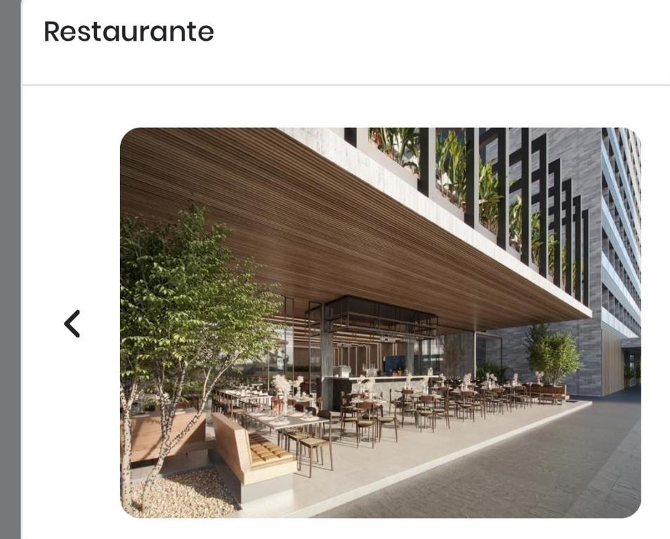 a building with a restaurant with tables and chairs at BEACH RESORT Em SALINAS in Salinópolis