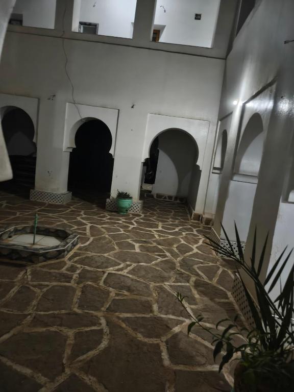 a room with a stone floor with arches at Hostel amodou in Tinerhir
