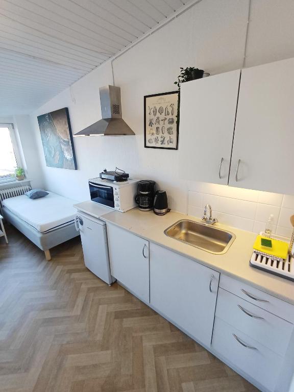 a kitchen with a sink and a counter top at Double room 1 with Free Parking in Nørresundby