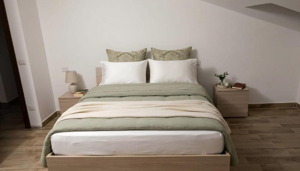 a bedroom with a large bed with two night stands at Il piccolo artista b&b in Naso