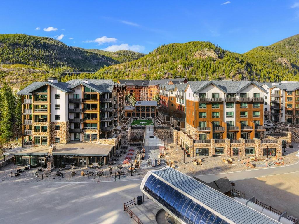 an aerial view of a resort with mountains in the background at Kindred Resort, A RockResort in Keystone
