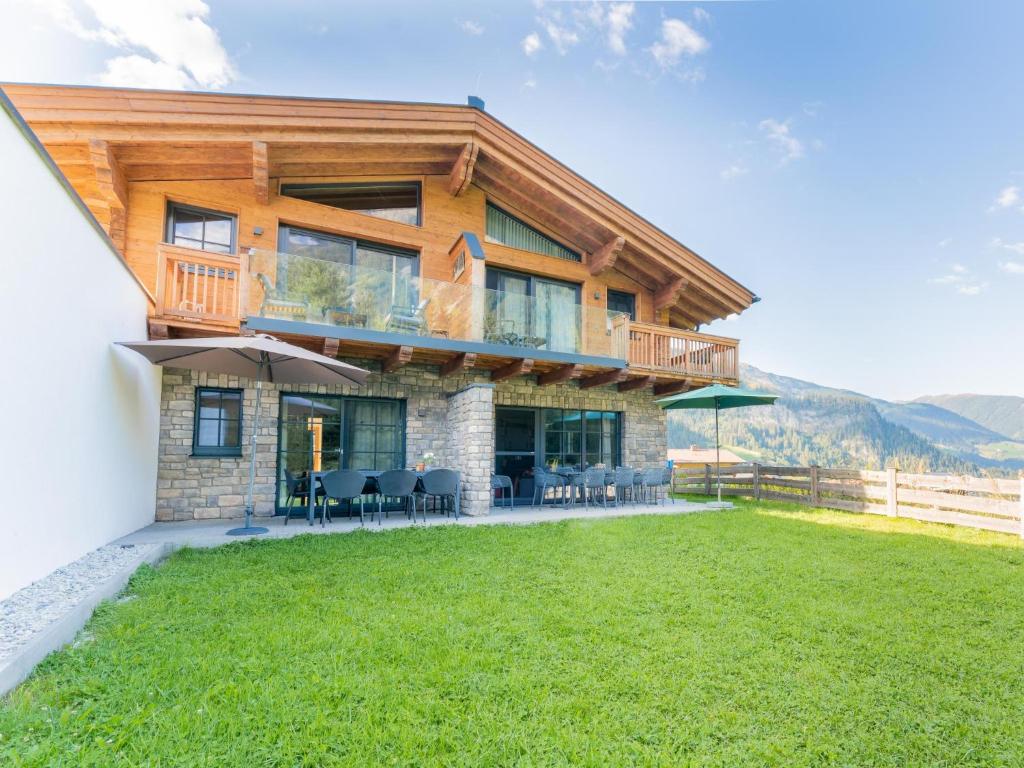 a large wooden house with a lawn in front of it at Chalet Sylvia in Krimml