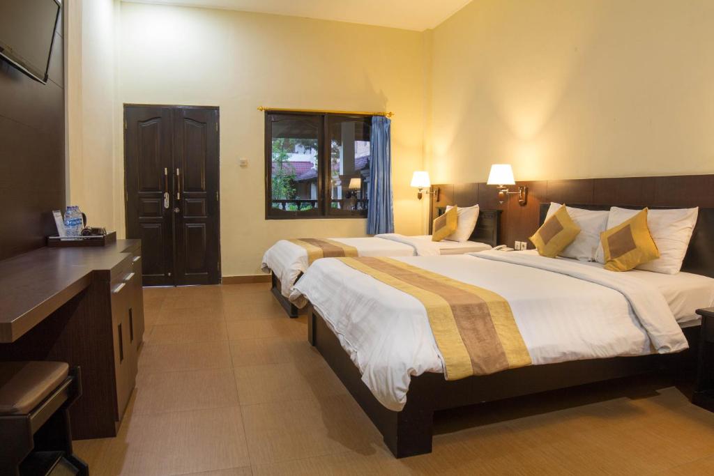 Postel nebo postele na pokoji v ubytování Bali Sandy Resort
