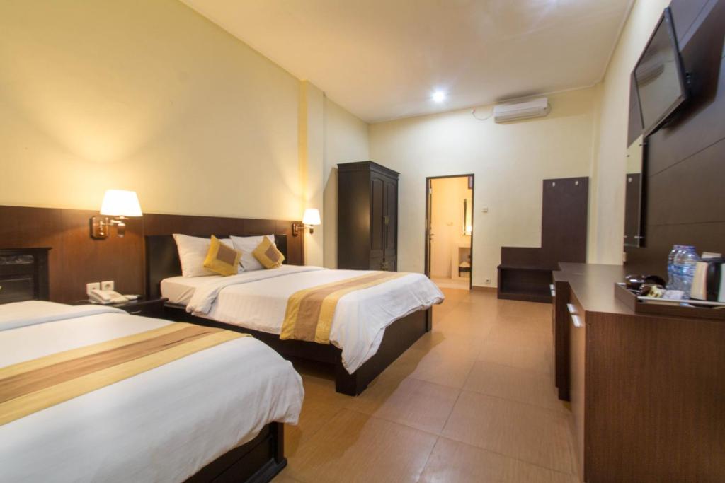 Postel nebo postele na pokoji v ubytování Bali Sandy Resort