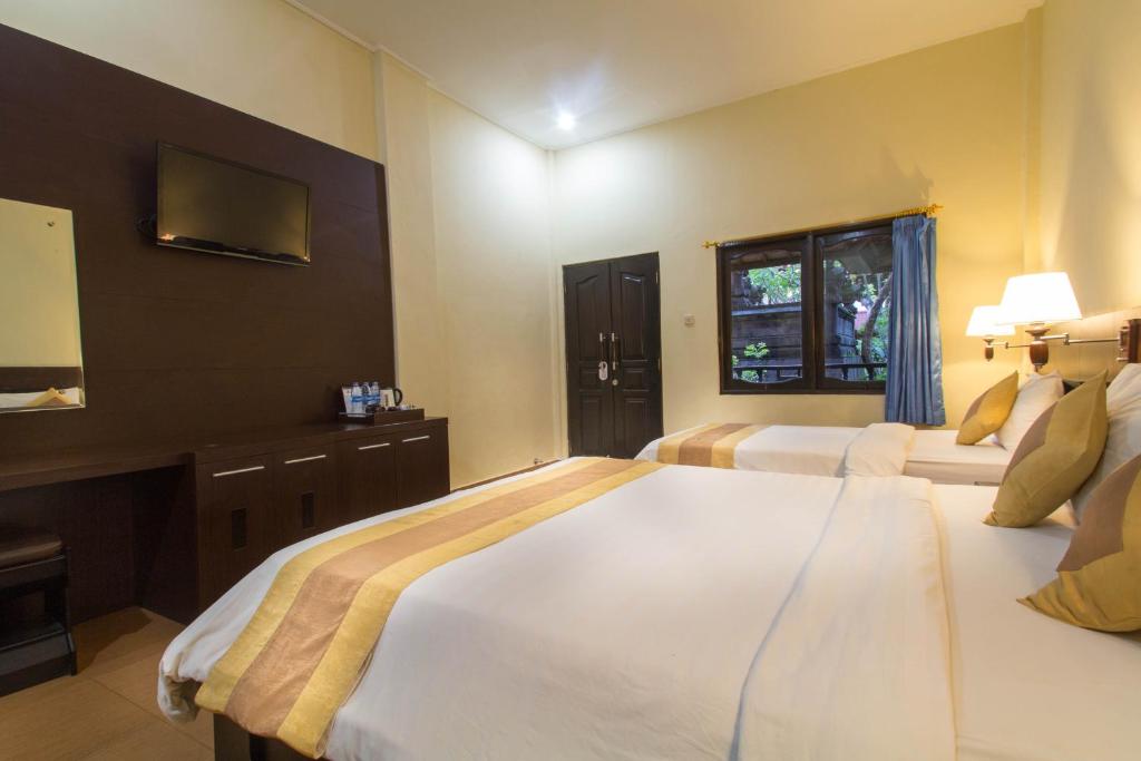 Postel nebo postele na pokoji v ubytování Bali Sandy Resort