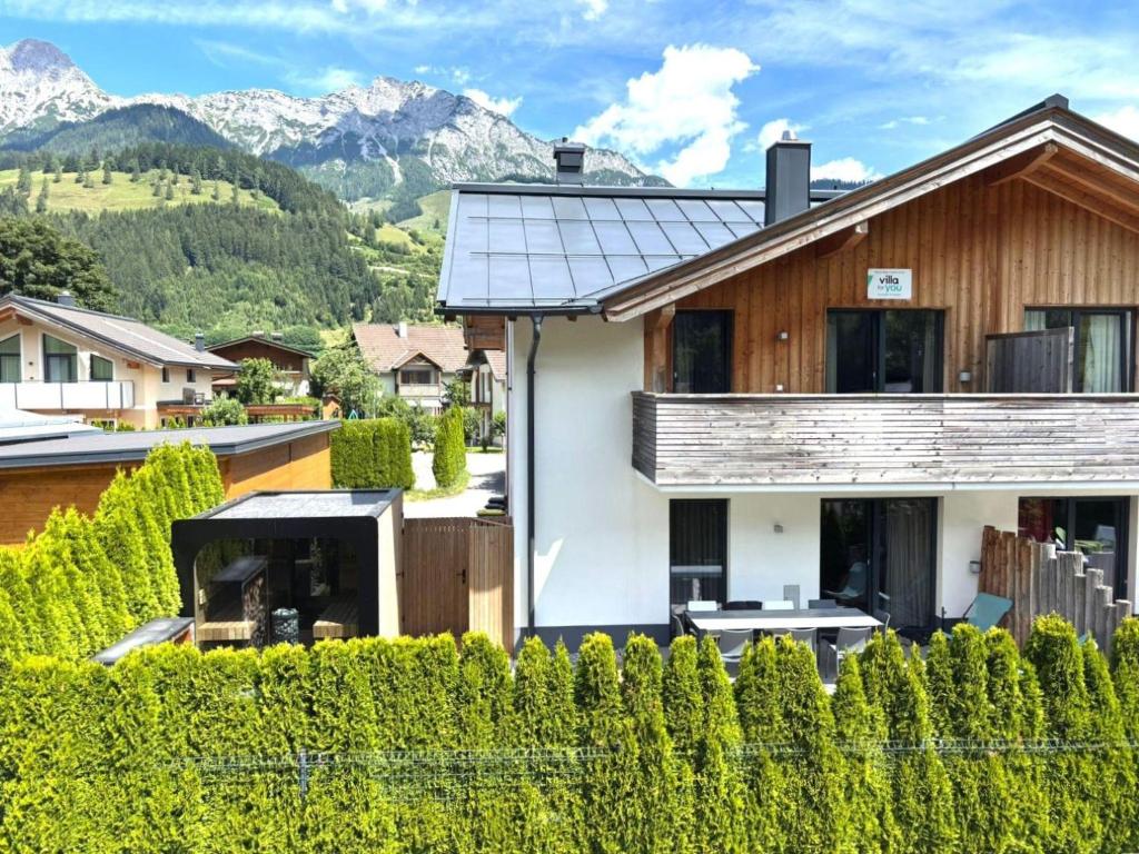 a house in the mountains with a fence at Hirnreit in Leogang
