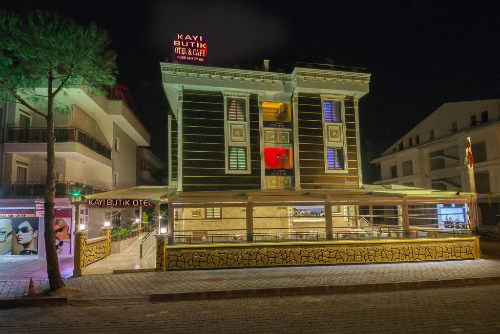 a building with a restaurant in front of it at night at Kayı Hotel in Fethiye