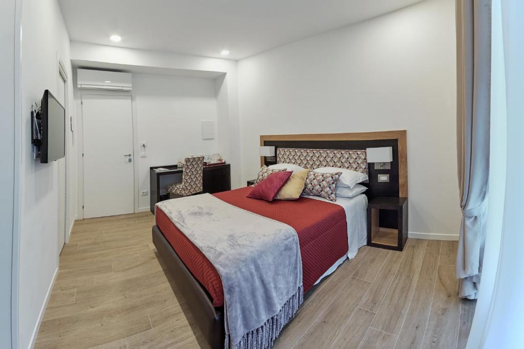 a bedroom with a bed with a red blanket at Dea Guest House in Sorrento
