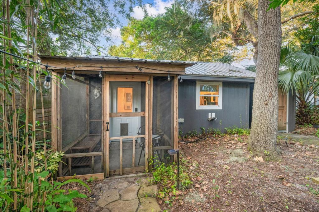 a small blue house with a door and a tree at Madeira Cottage - Amphitheater in St. Augustine