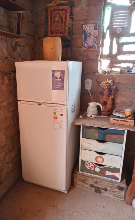 a white refrigerator next to a table with drawers at casa domo in Maimará