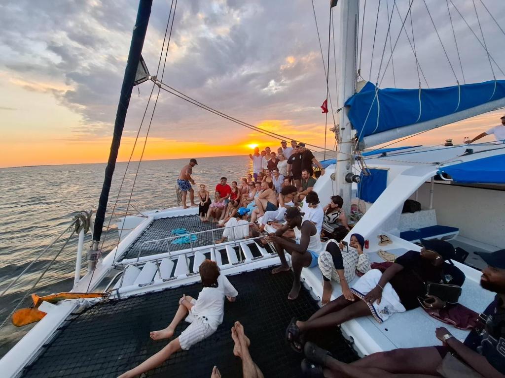 a group of people sitting on the deck of a boat at Balade de 3 heures en Catamaran de Luxe djerba in Houmt Souk