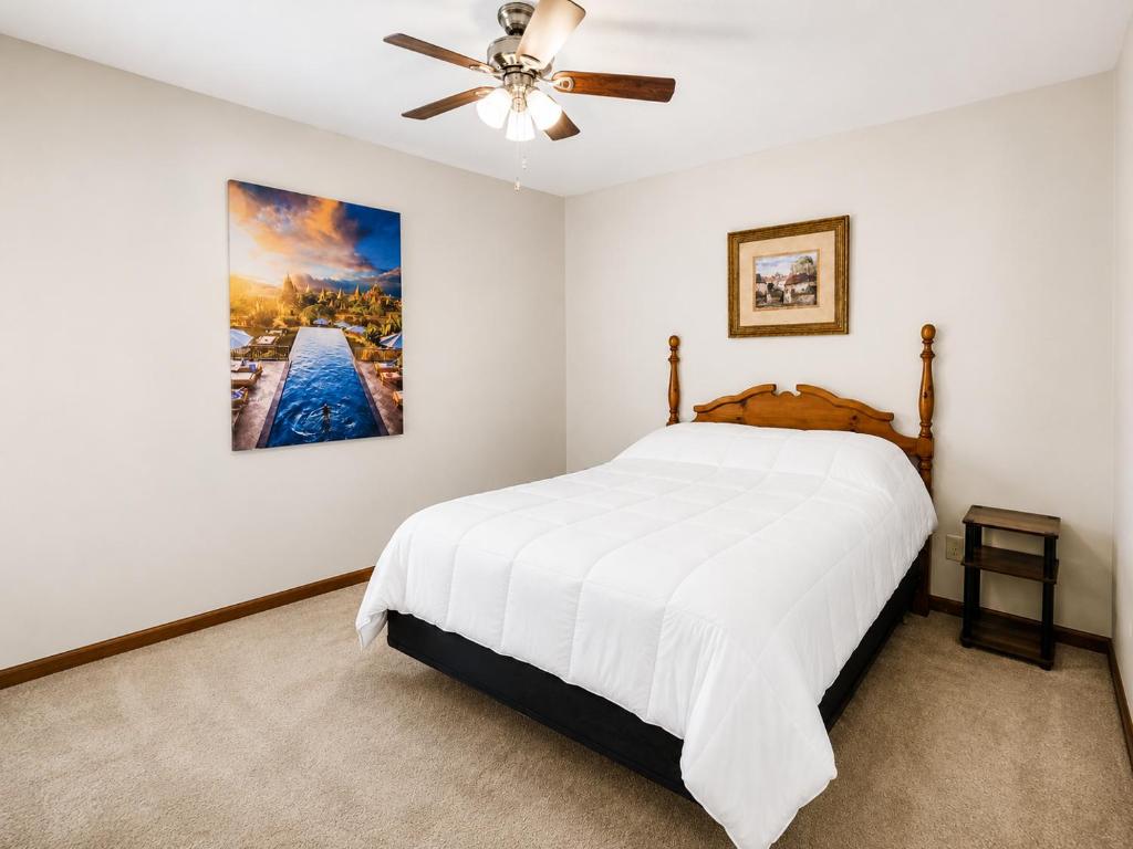 a bedroom with a bed and a ceiling fan at Kaw Drive Guest House in Olathe