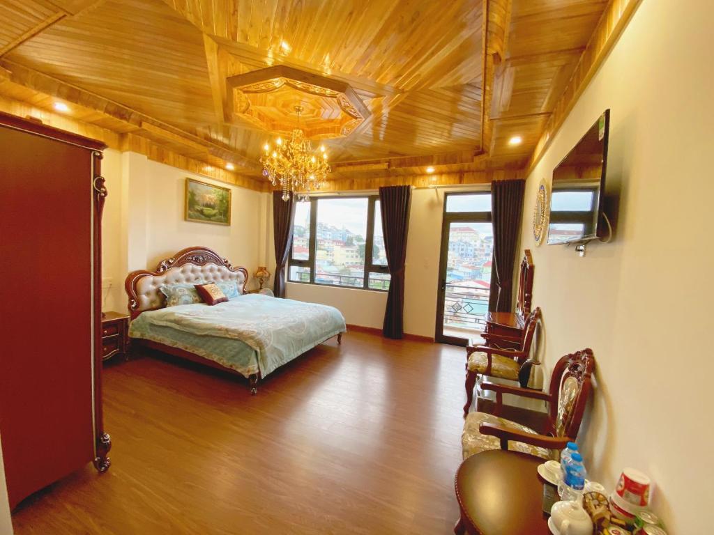 a bedroom with a bed and a chandelier at S79 Hoa Dang Dalat in Da Lat