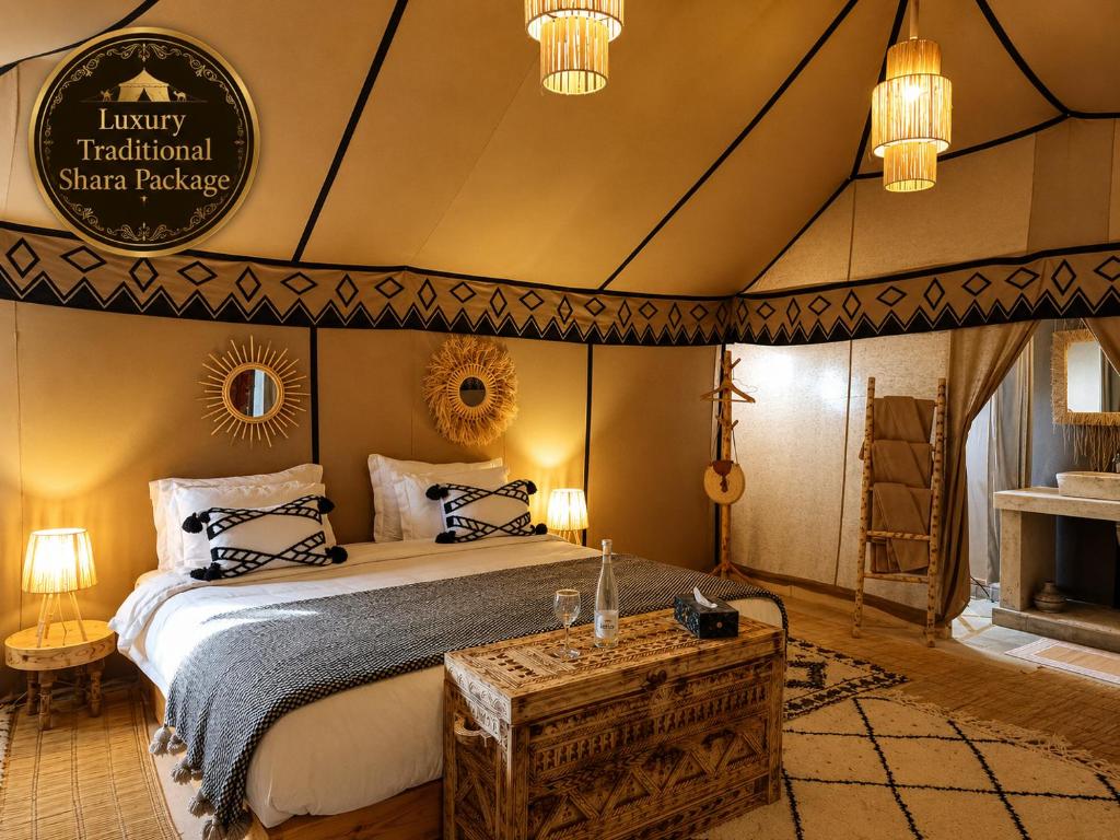 a bedroom with a bed in a tent at Luxury Traditional Sahara Package in Merzouga