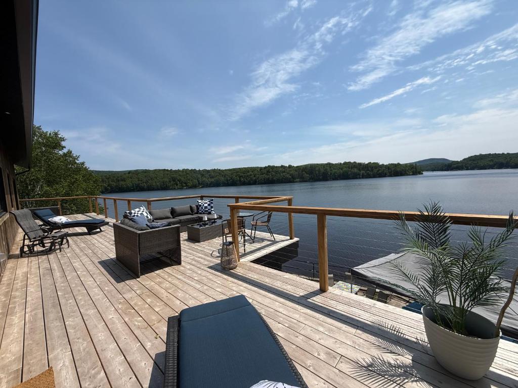 a deck with a view of a body of water at Le Quai 163 in La Macaza
