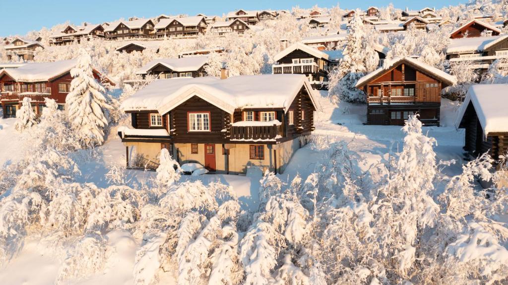 a lodge in the snow with snow covered trees at Ideal For Families 6 Bedrooms And Sauna in Beitostøl