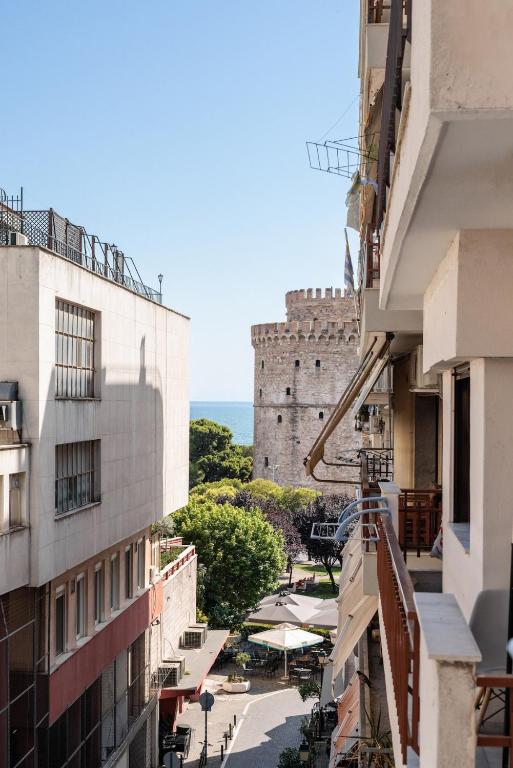 a view of a castle from between buildings at White Tower Elegance in Thessaloniki