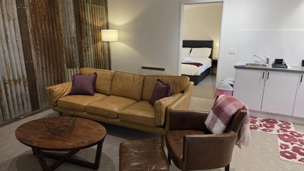 a living room with a couch and a bed at Alpinwood in Dinner Plain