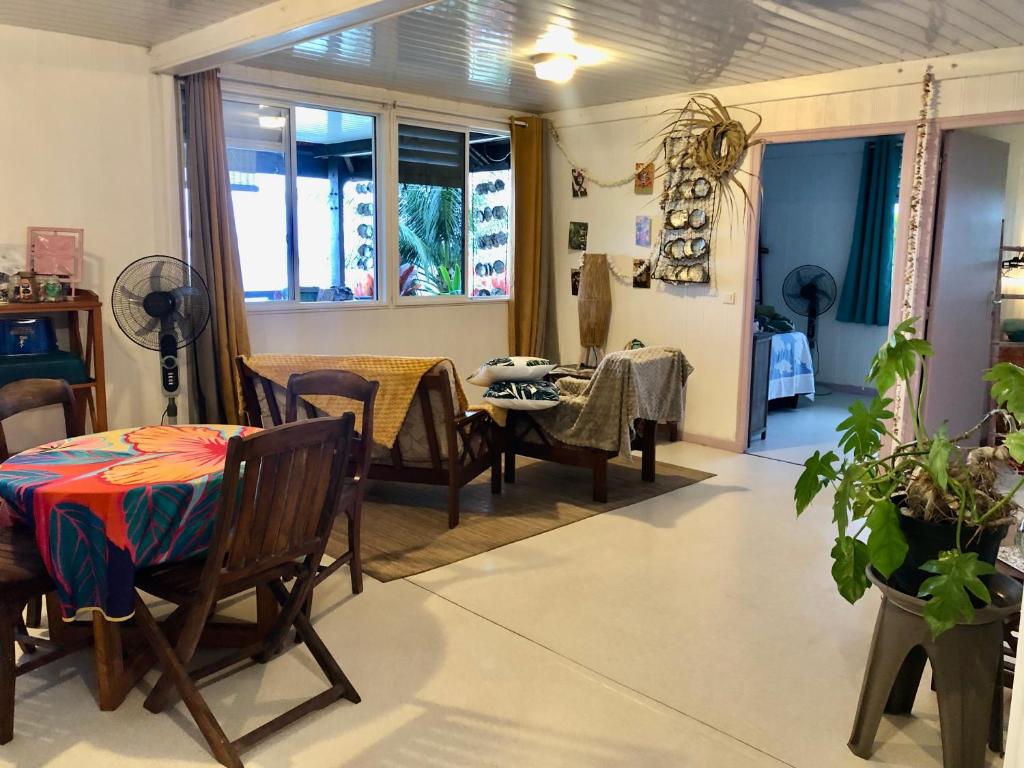a room with a table and chairs and a dining room at Fare Mirimiri in Uturoa