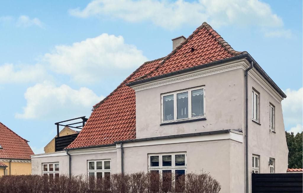 a white house with a red roof at Amazing Apartment In Hundested With Wifi in Hundested