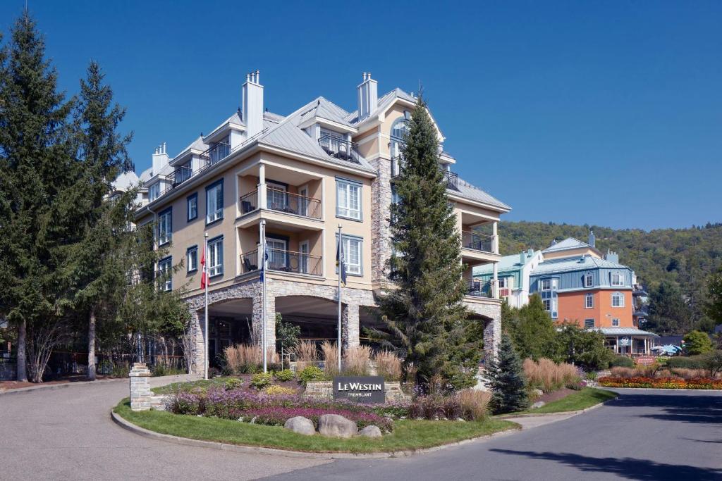 a large apartment building with a sign in front of it at Le Westin Tremblant in Mont-Tremblant