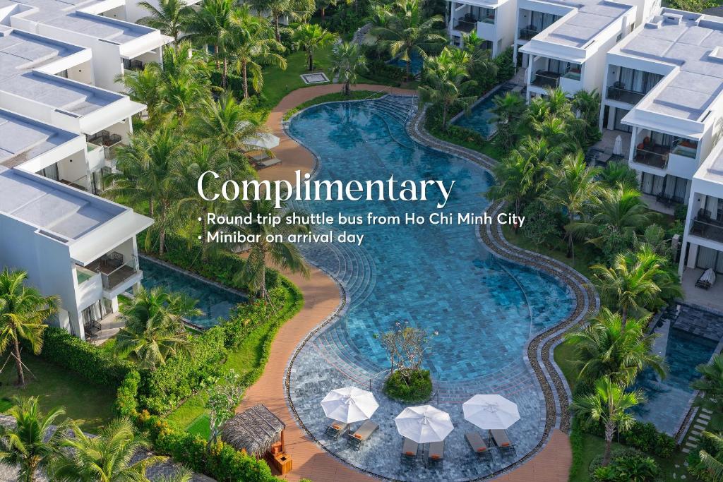 a rendering of a resort style swimming pool with umbrellas at Angsana Ho Tram in Ho Tram