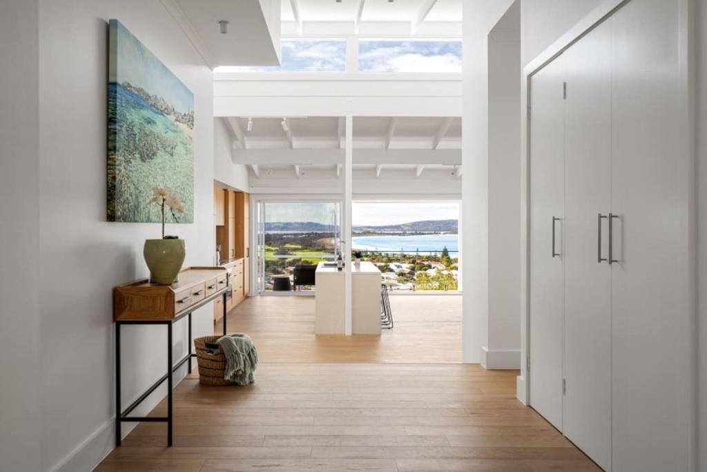 a white hallway with a view of the ocean at The View, Albany Holiday House in Albany