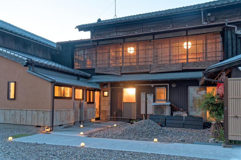 a house with lights on the side of it at ISEZI Private Estate in Shibata