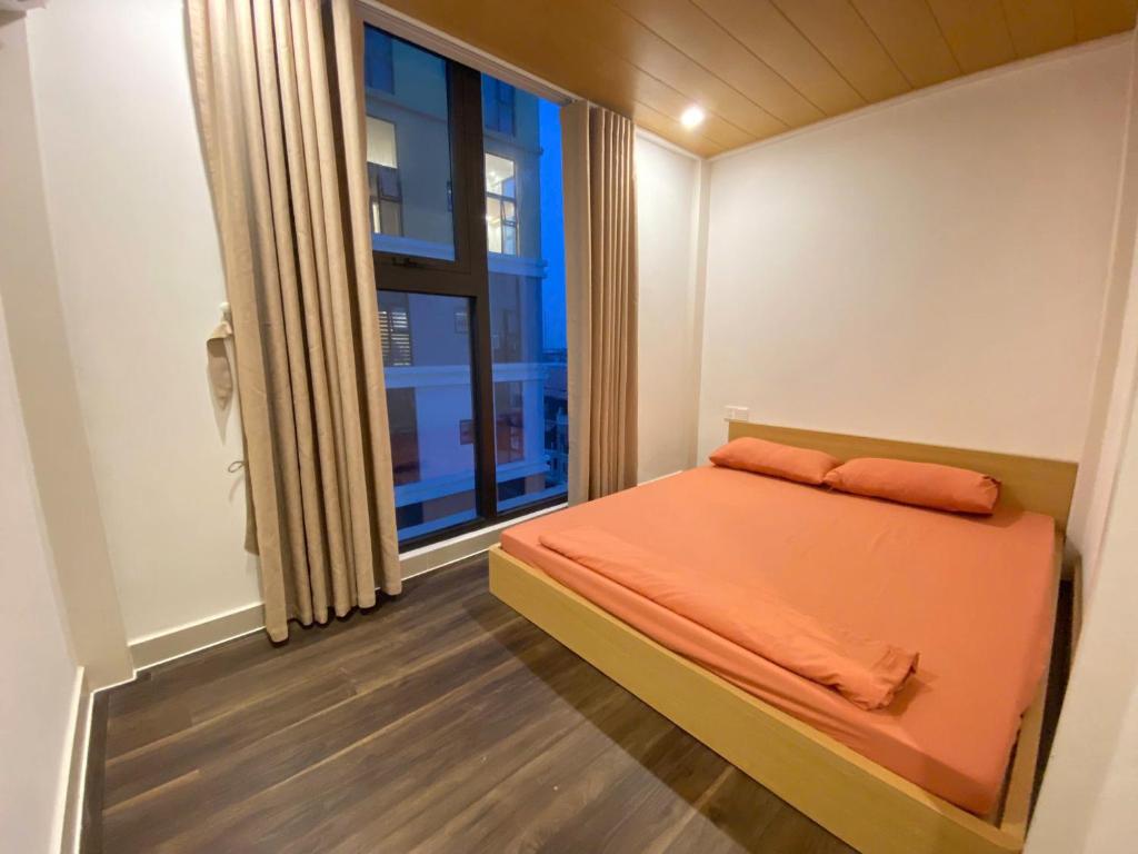a small bedroom with a bed and a window at Sun Uban City Hà Nam in Quang Ãm