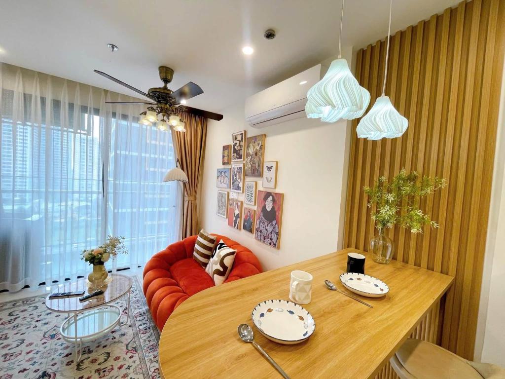 a living room with a table and a red couch at Aquar Grand Park in Gò Công