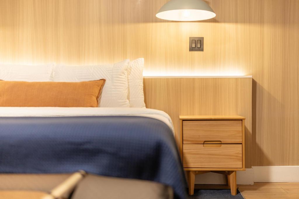 a bedroom with a bed and a nightstand with a blue blanket at The Iceberg Tahoe in South Lake Tahoe