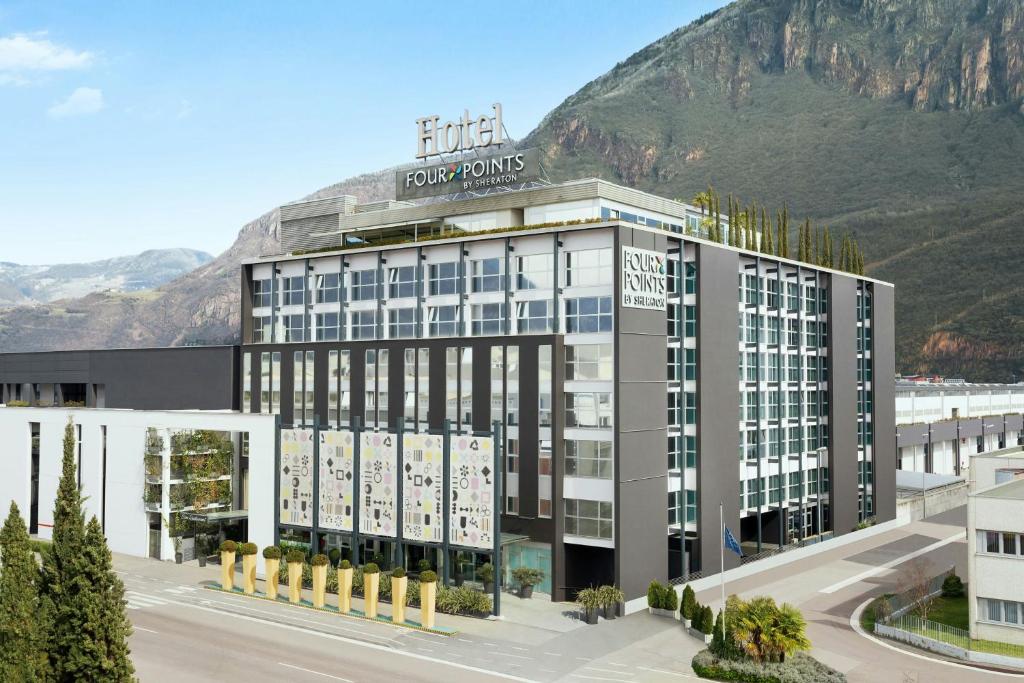 a rendering of a hotel with a mountain in the background at Four Points Sheraton Bolzano Bozen in Bolzano