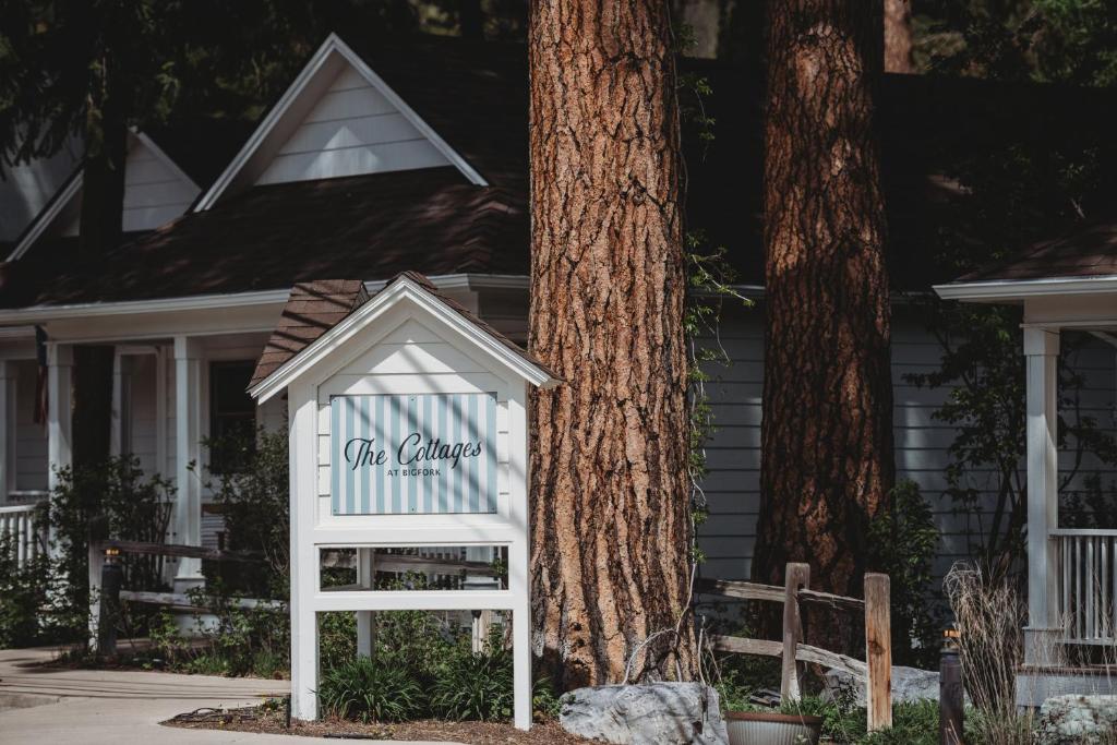 a white sign in front of a house at The Cottages at Bigfork in Bigfork