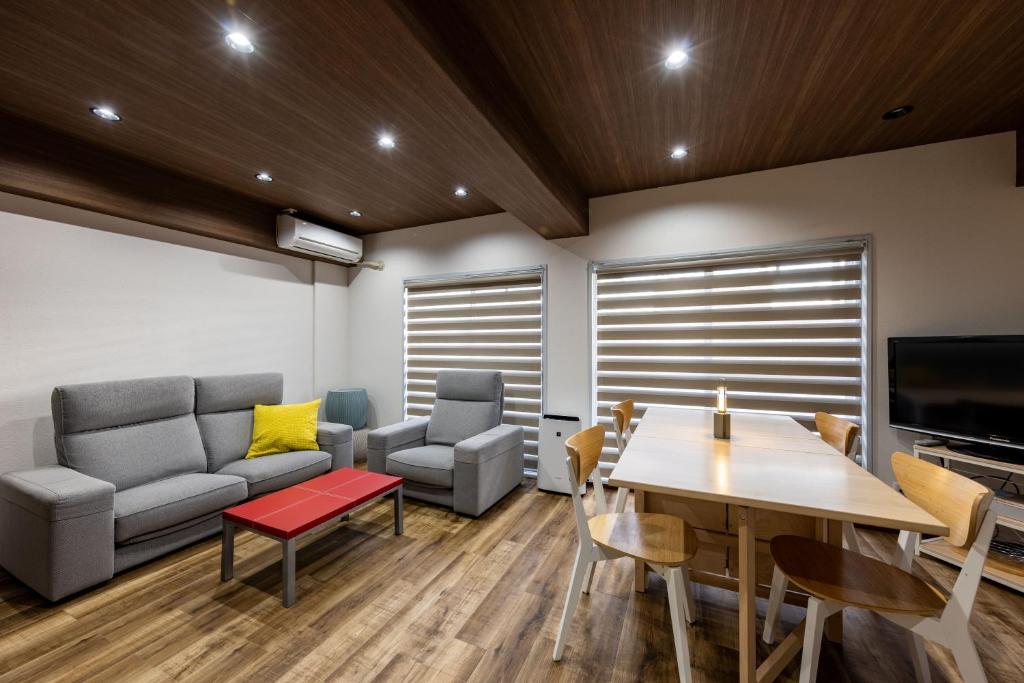 a living room with a couch and a table at Kame Ame House in Kameoka