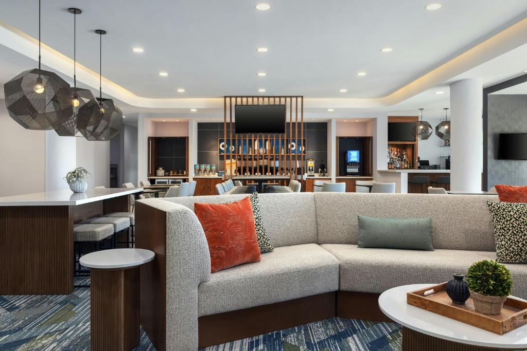 a living room with a couch and a kitchen at SpringHill Suites by Marriott Dayton Vandalia in Murlin Heights