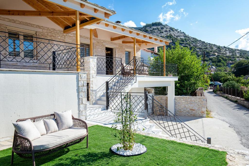 a house with a couch on the grass at The 2D Stay in Theológos
