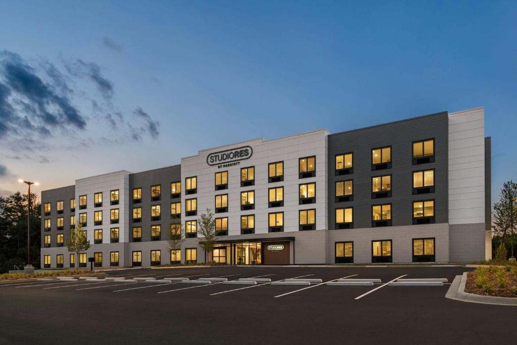 an office building with lights on in a parking lot at StudioRes by Marriott LaGrange in La Grange