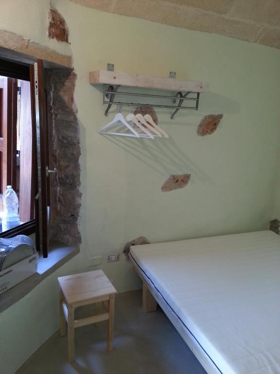 Postel nebo postele na pokoji v ubytování La Torre di Merlino
