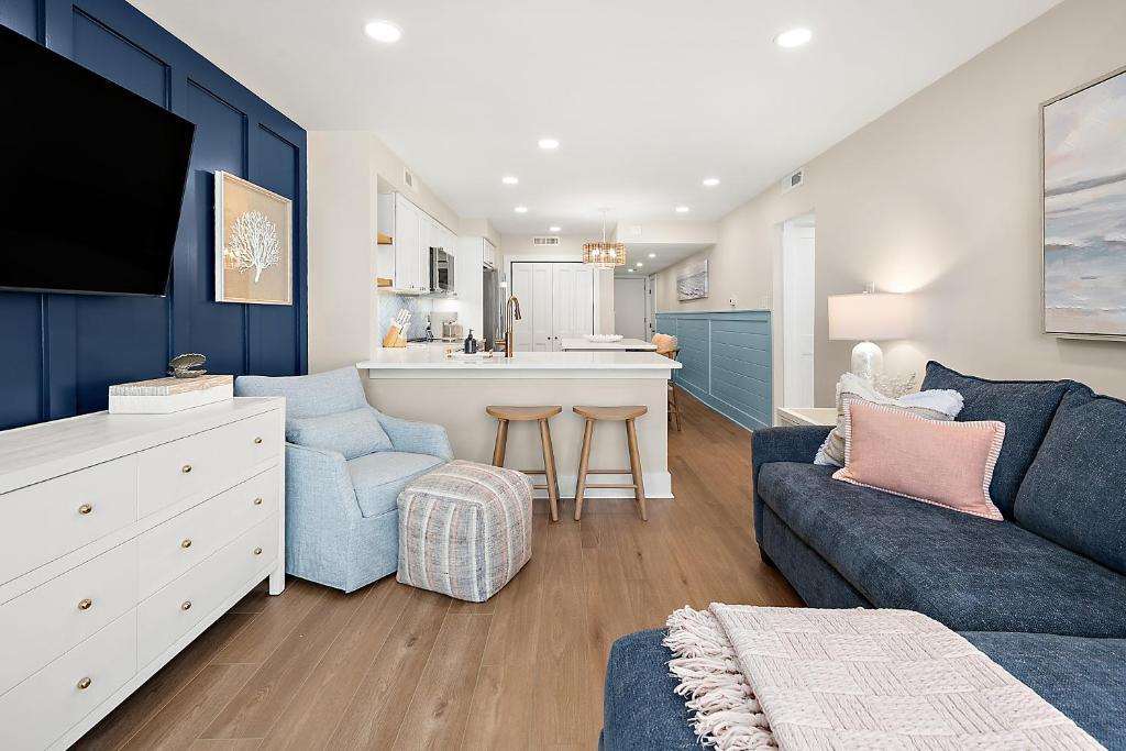 a living room with a couch and a kitchen at Ocean Side Beach Condo in Ocean City