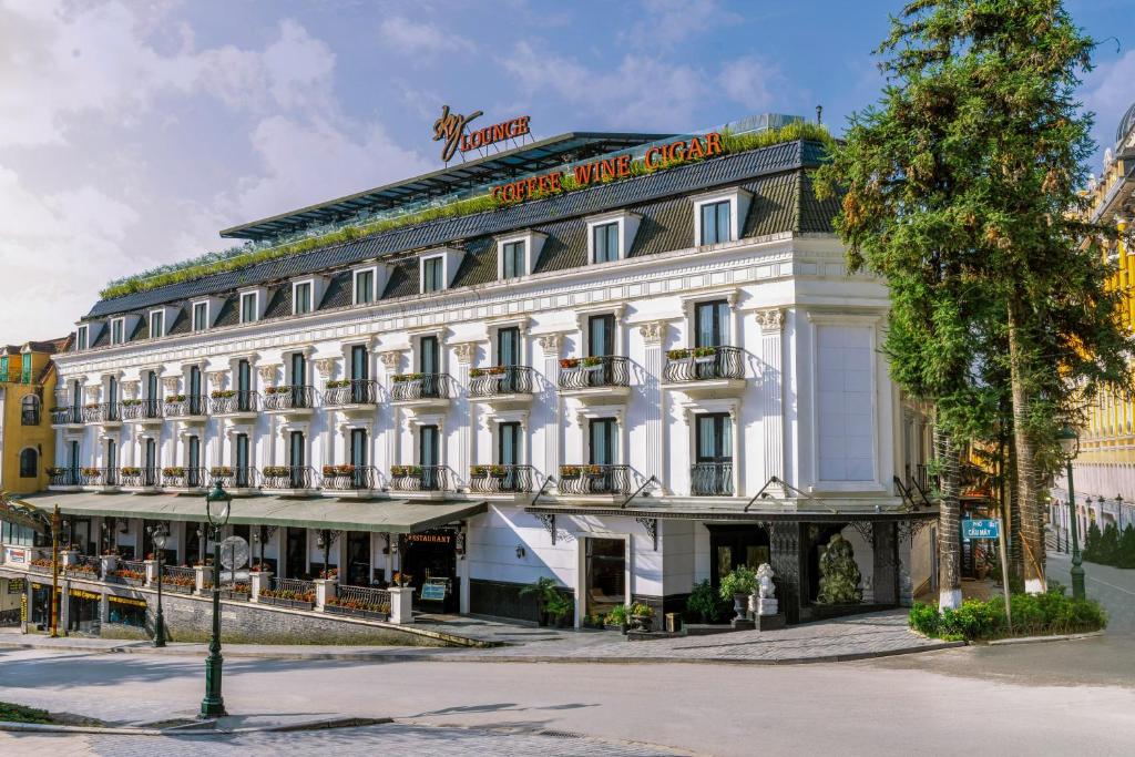 a large white building with a sign on it at Hotel Sapa Square, Affiliated by Meliá in Sapa
