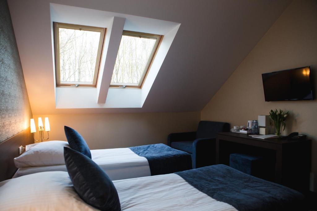 Posteľ alebo postele v izbe v ubytovaní Hotel Cztery Pory Roku