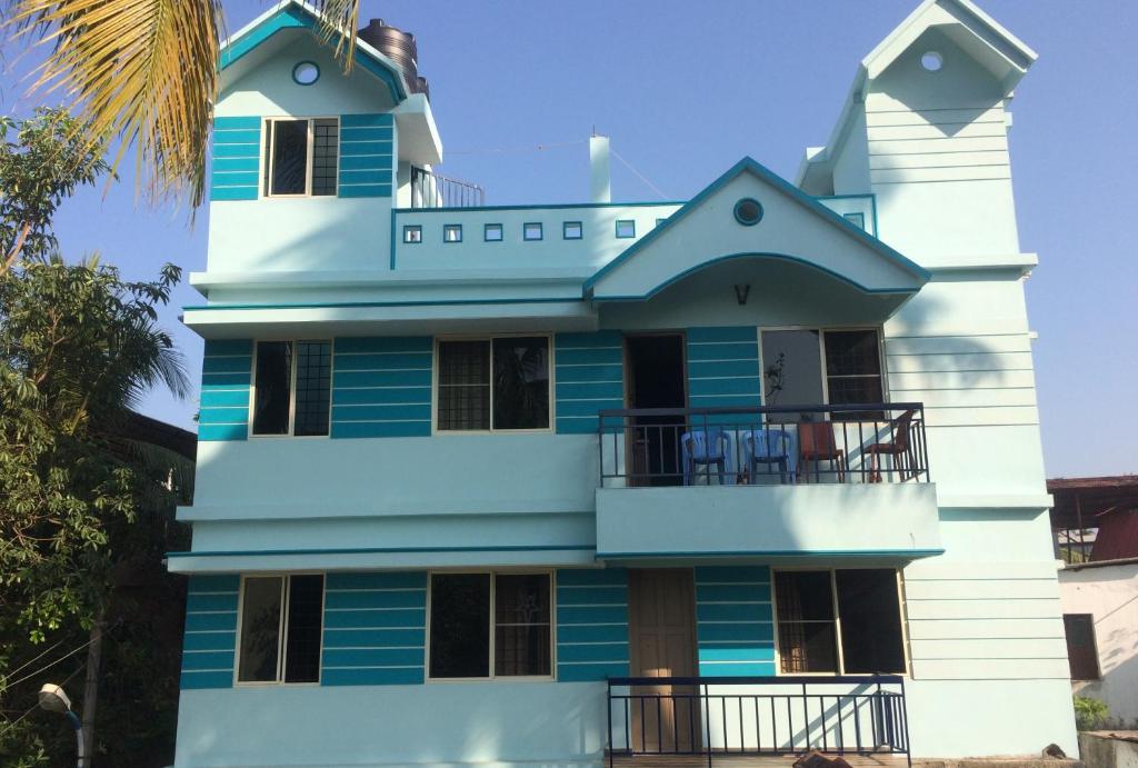 a blue and white building with a balcony at Cherish homestay in Cochin