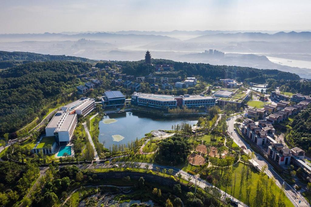 an aerial view of a city with a lake at Meliá Chongqing in Chongqing