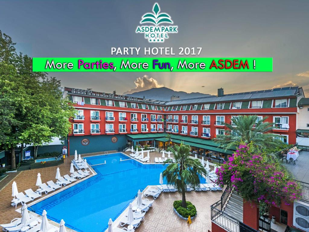 a view of a hotel with a pool and chairs at Asdem Park Otel in Kemer