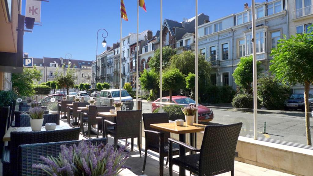 a restaurant with tables and chairs on a street at Catalonia Brussels in Brussels