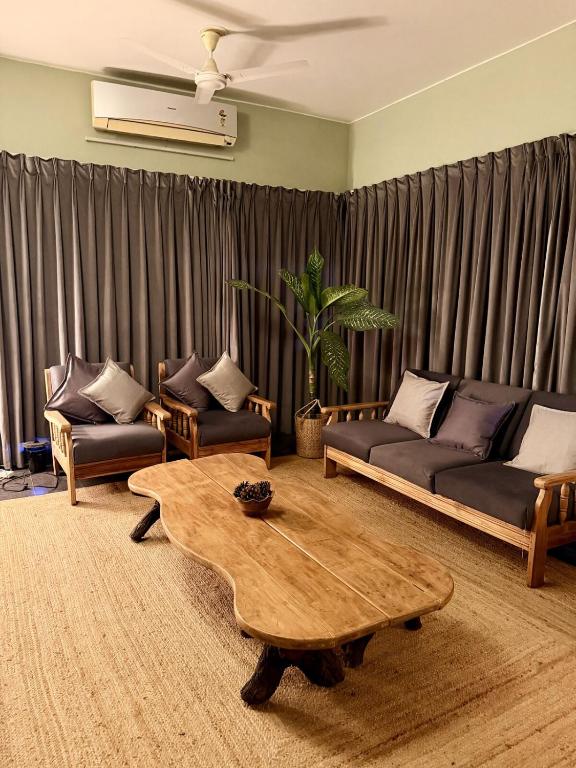 a living room with two couches and a coffee table at The Saanj Villa in Sānand
