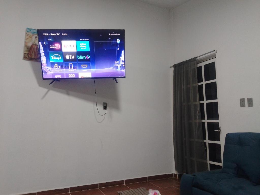 a flat screen tv hanging on a wall in a living room at Oscar in Poza Rica de Hidalgo